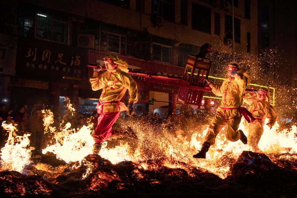 © Ni Chen, winner of the ‘Celebration!’ category with Above the Flames: Jumping the fire